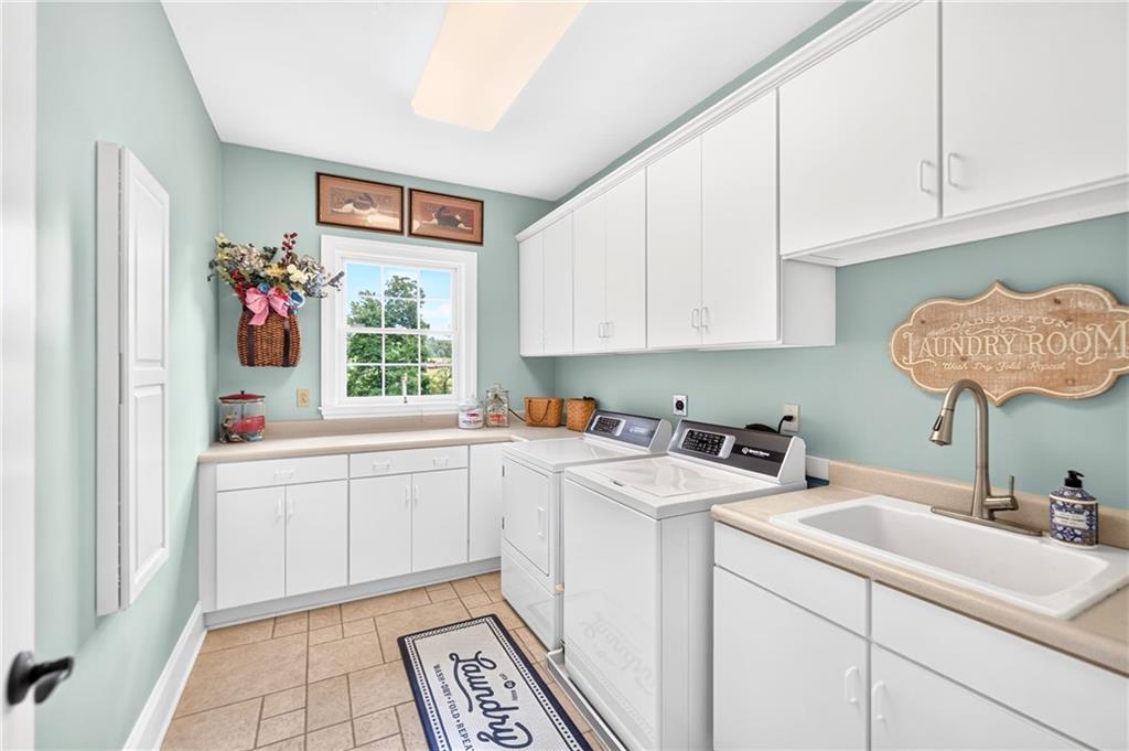 486 Settler Road Ligonier, PA 15658 - Photo 24 of 49 First floor, Speed Queen Washer and Dryer, tons of cabinetry & storage, utility sink, new hardware and yes, that's a wall mounted ironing board which works!