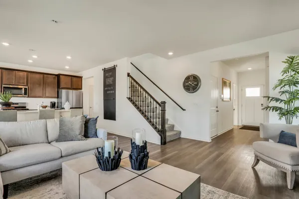 a living room with furniture and wooden floor