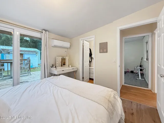 a bedroom with a bed and a large mirror
