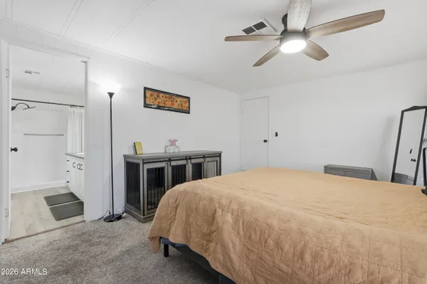 a bedroom with a bed and a ceiling fan