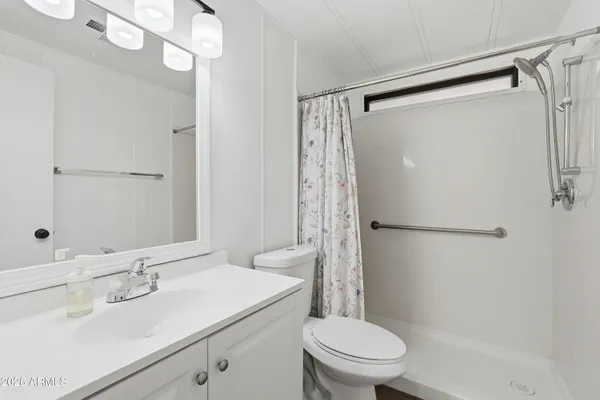a bathroom with a sink toilet and shower