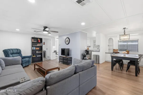 a living room with furniture kitchen view and a table