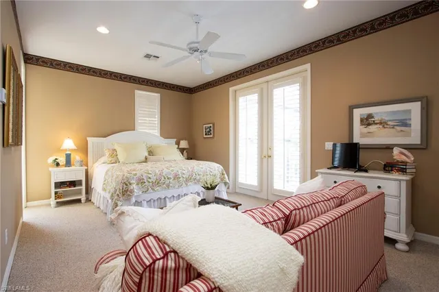 a bedroom with a large bed and a chandelier