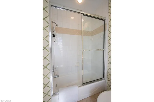 a bathroom with a shower and a sink