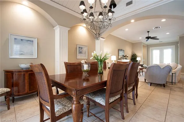 a view of a dining room with furniture and chandelier
