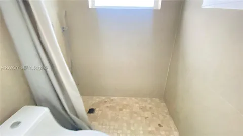 a view of a bathroom with a window and a ceiling fan