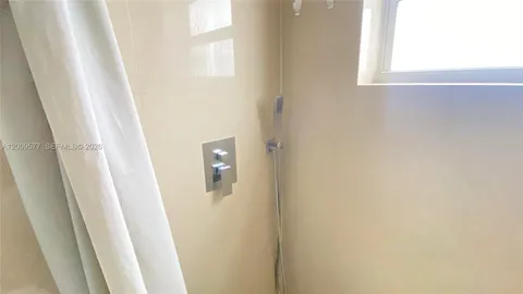 a utility room with cabinets washer and dryer