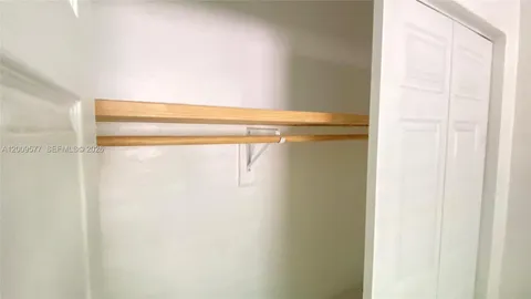 a white toilet sitting next to a white sink
