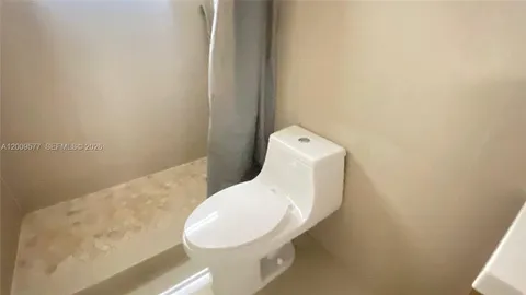 a view of an empty room and a window