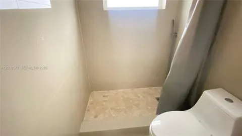 a bathroom with a sink a mirror and a shower