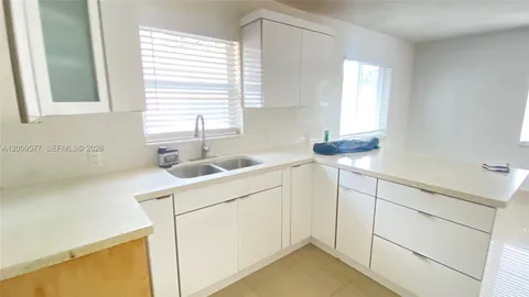 a utility room with cabinets washer and dryer