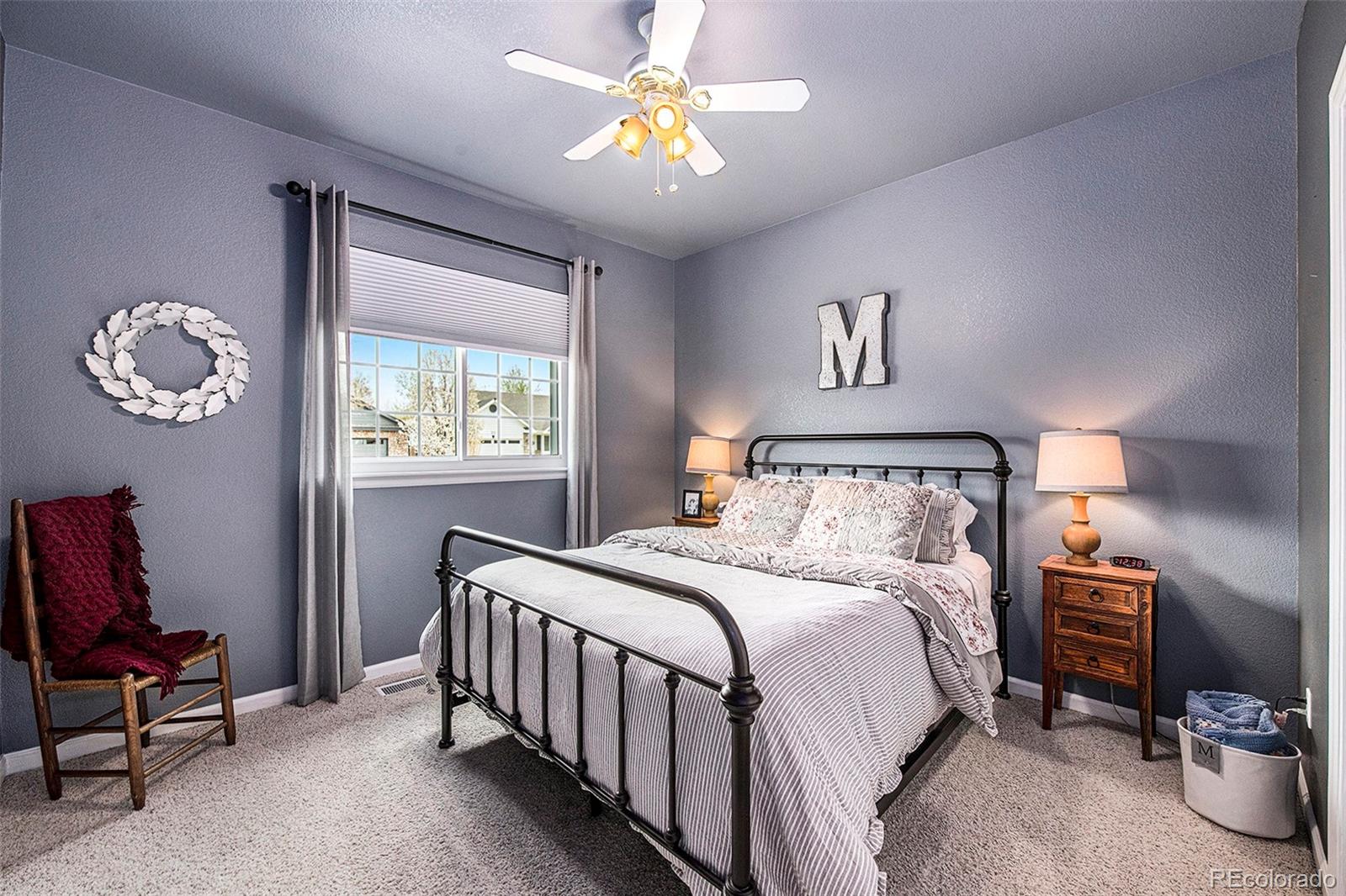 320 Granite Way Johnstown, CO 80534 - Photo 18 of 39 a bedroom with a bed and a chandelier