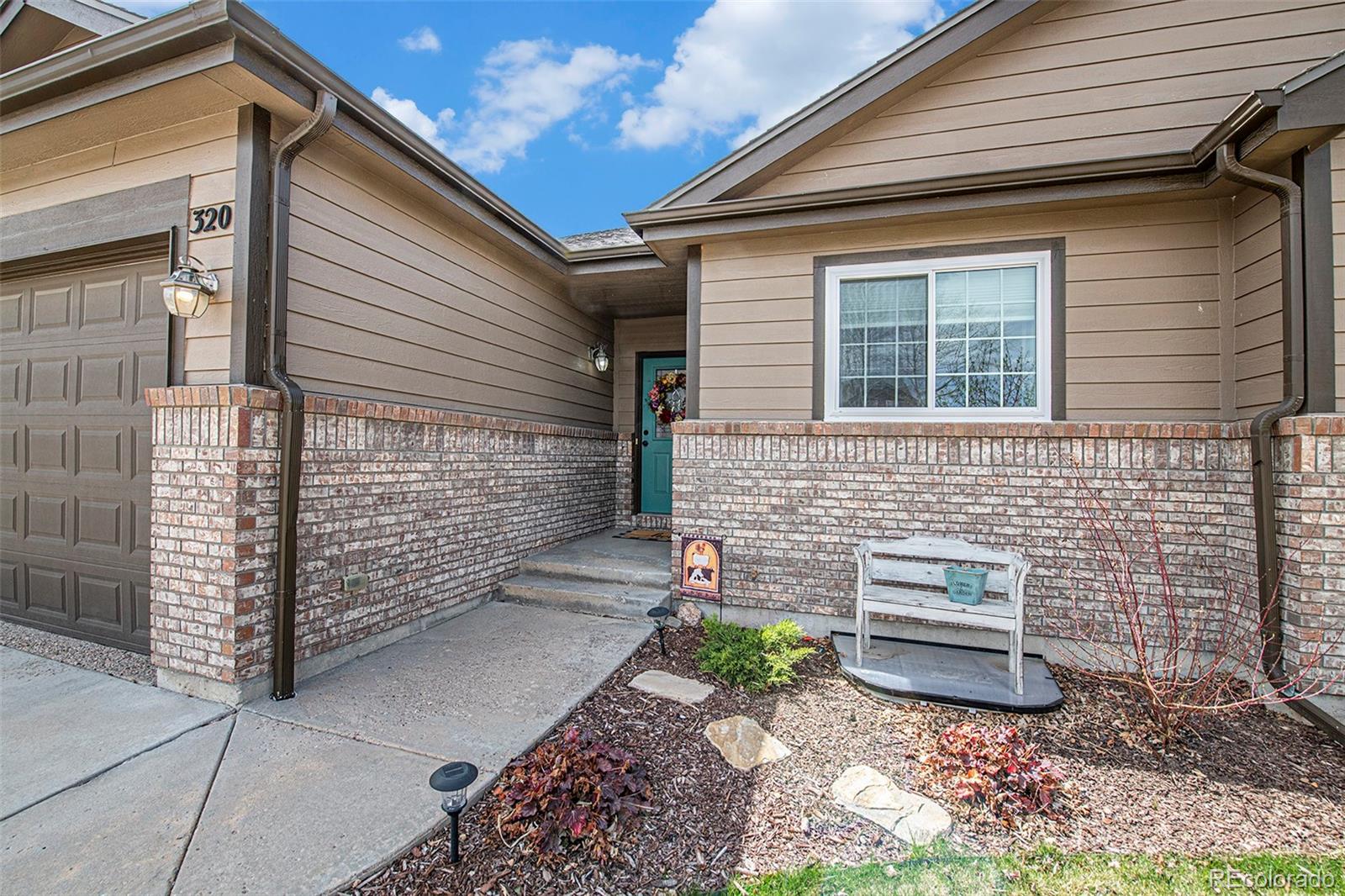 320 Granite Way Johnstown, CO 80534 - Photo 2 of 39 a view of a door and chair and fire pit