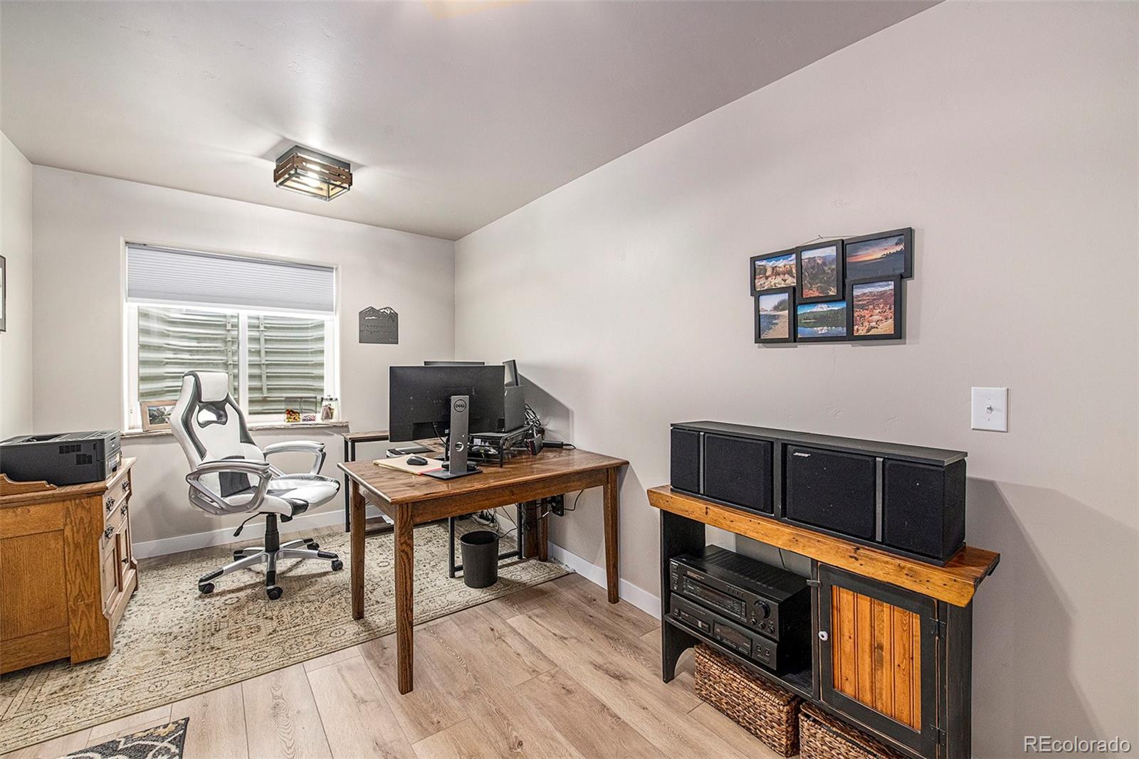 320 Granite Way Johnstown, CO 80534 - Photo 23 of 39 a view of a workspace with furniture and a window