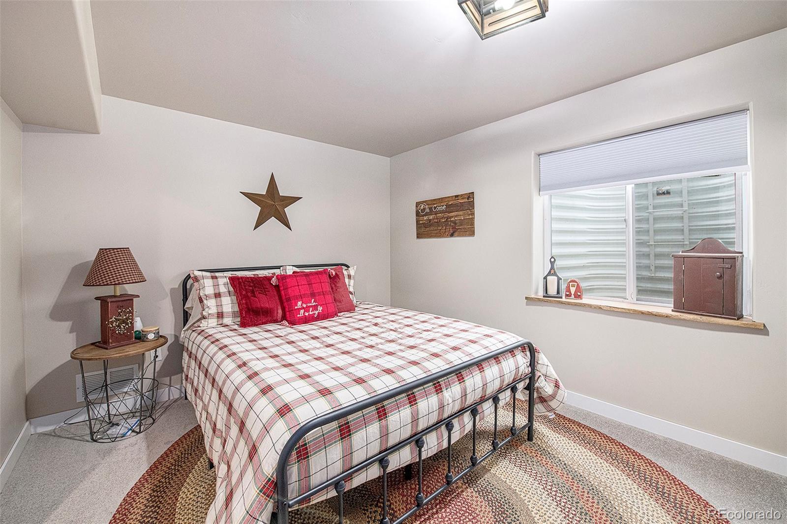 320 Granite Way Johnstown, CO 80534 - Photo 24 of 39 a bedroom with a large bed and a window