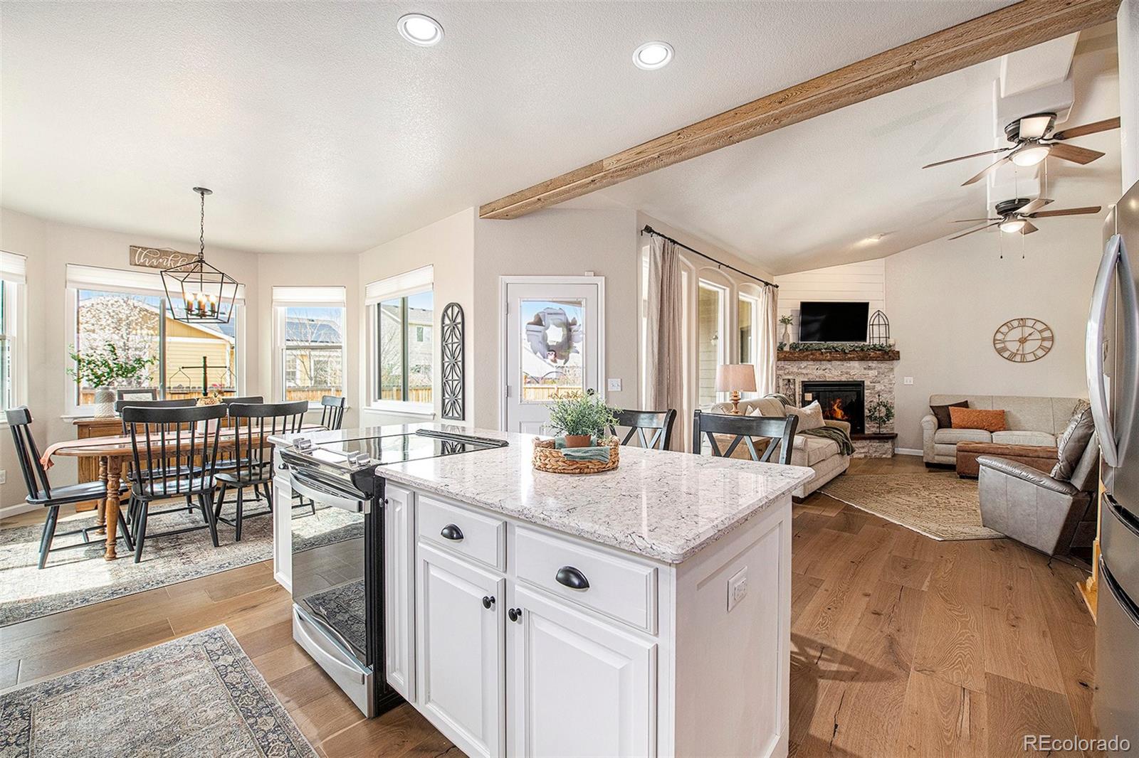 320 Granite Way Johnstown, CO 80534 - Photo 6 of 39 a kitchen with sink cabinets and living room view