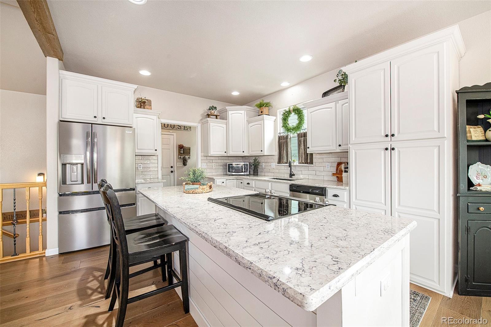 320 Granite Way Johnstown, CO 80534 - Photo 8 of 39 a kitchen with granite countertop a counter space stainless steel appliances and cabinets