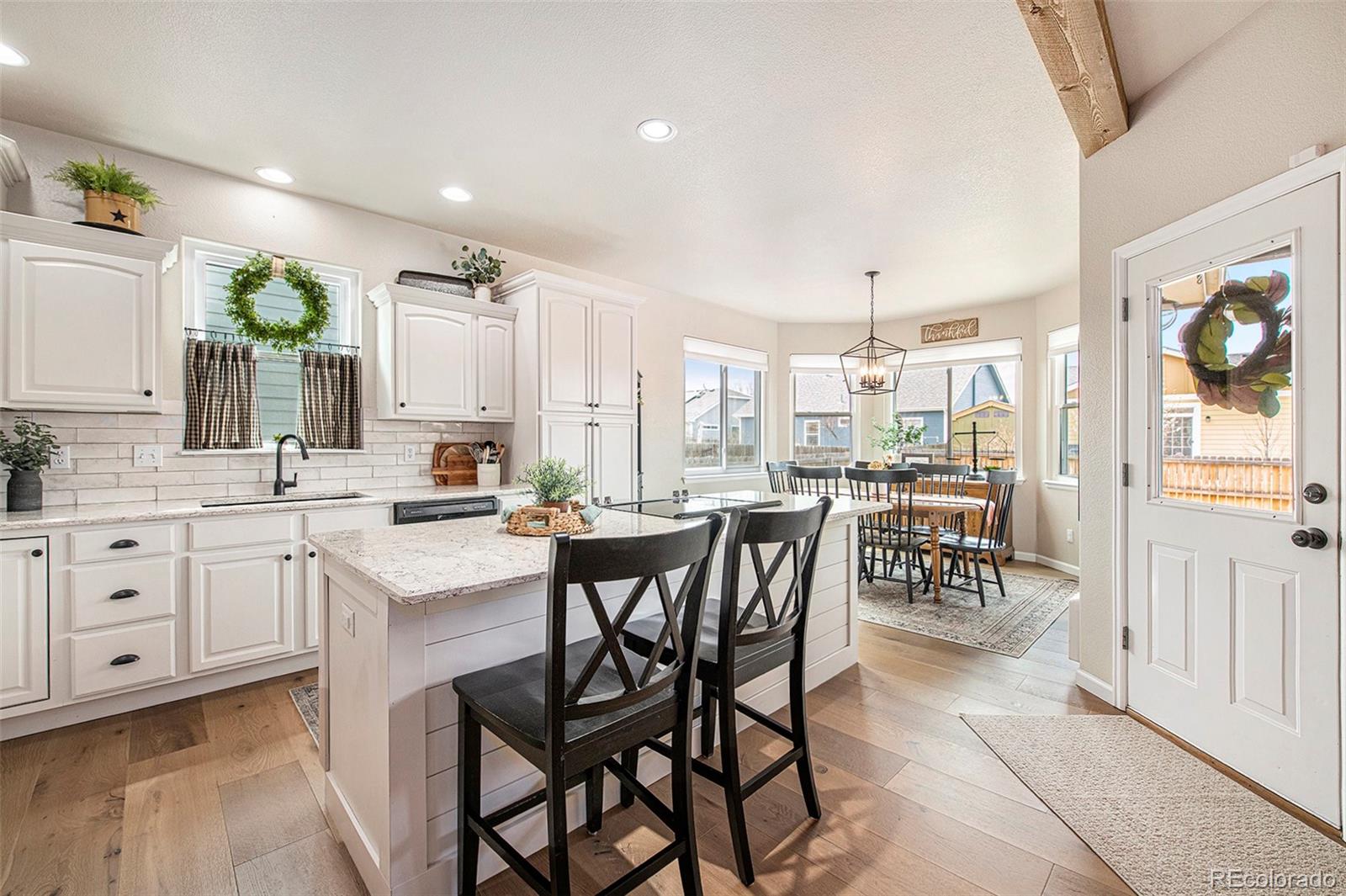 320 Granite Way Johnstown, CO 80534 - Photo 9 of 39 a large kitchen with a table and chairs