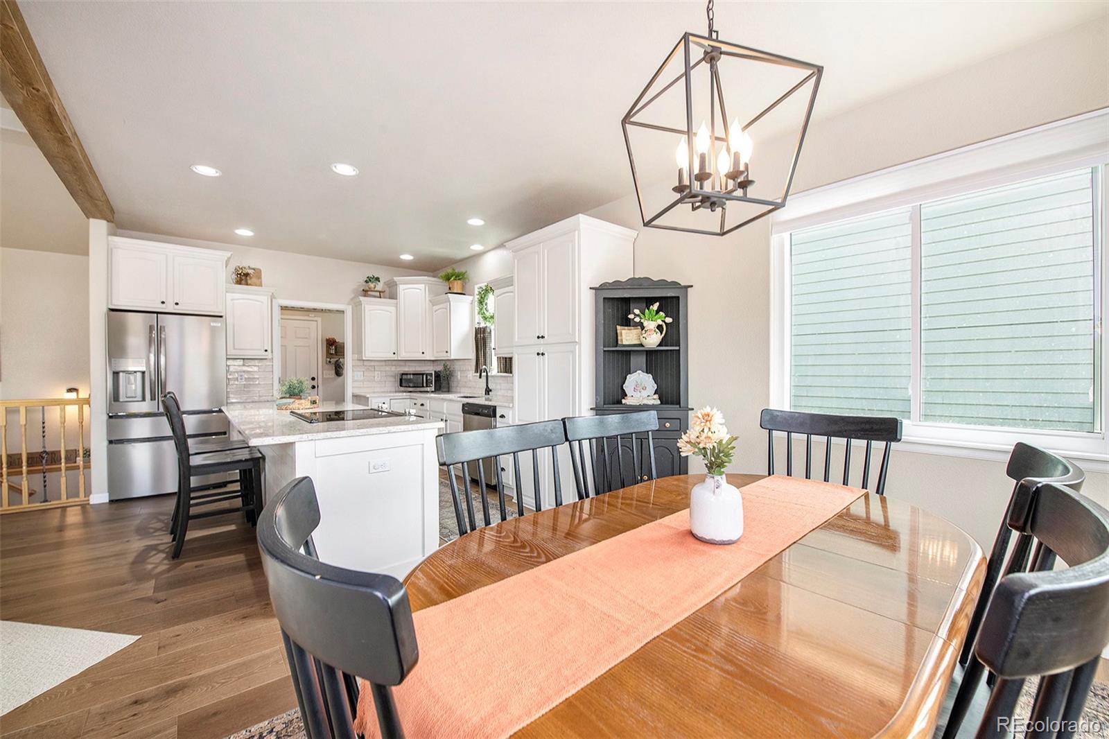320 Granite Way Johnstown, CO 80534 - Photo 10 of 39 a view of a dining room with furniture window and wooden floor