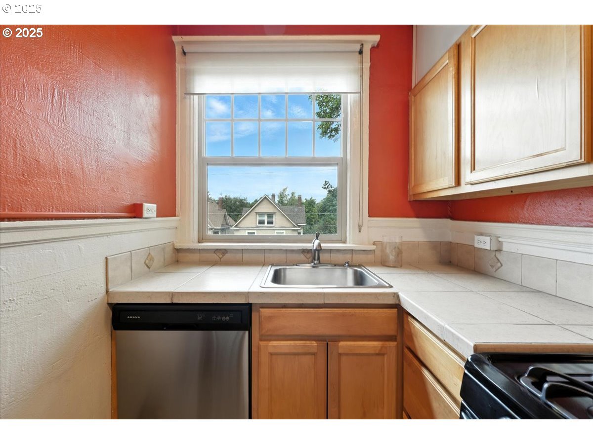 2109 Northwest Irving Street, Unit 304 Portland, OR 97210 - Photo 18 of 25 a kitchen with a sink and a window