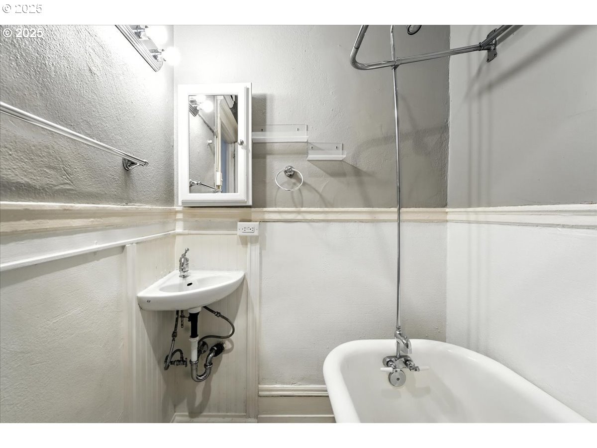 2109 Northwest Irving Street, Unit 304 Portland, OR 97210 - Photo 23 of 25 a bathroom with a sink and mirror