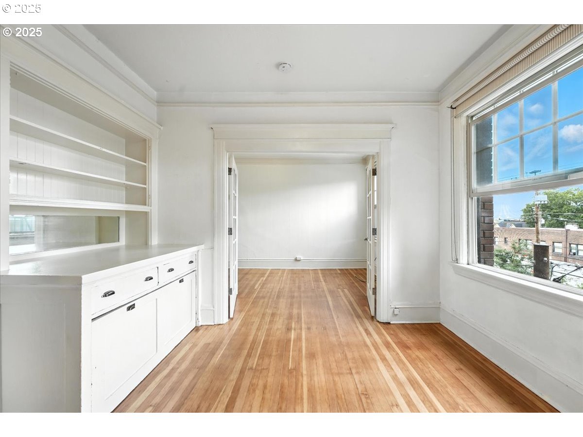 2109 Northwest Irving Street, Unit 304 Portland, OR 97210 - Photo 10 of 25 a view of a hardwood floor and windows in an empty room