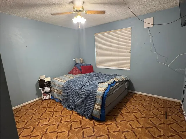 a bedroom with a bed and a chandelier