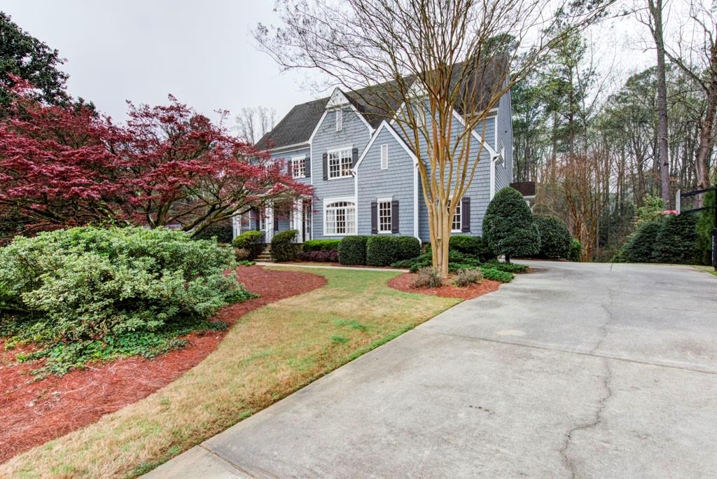 2920 Rockingham Drive Northwest Atlanta, GA 30327 - Photo 1 of 1 a front view of a house with a yard and potted plants