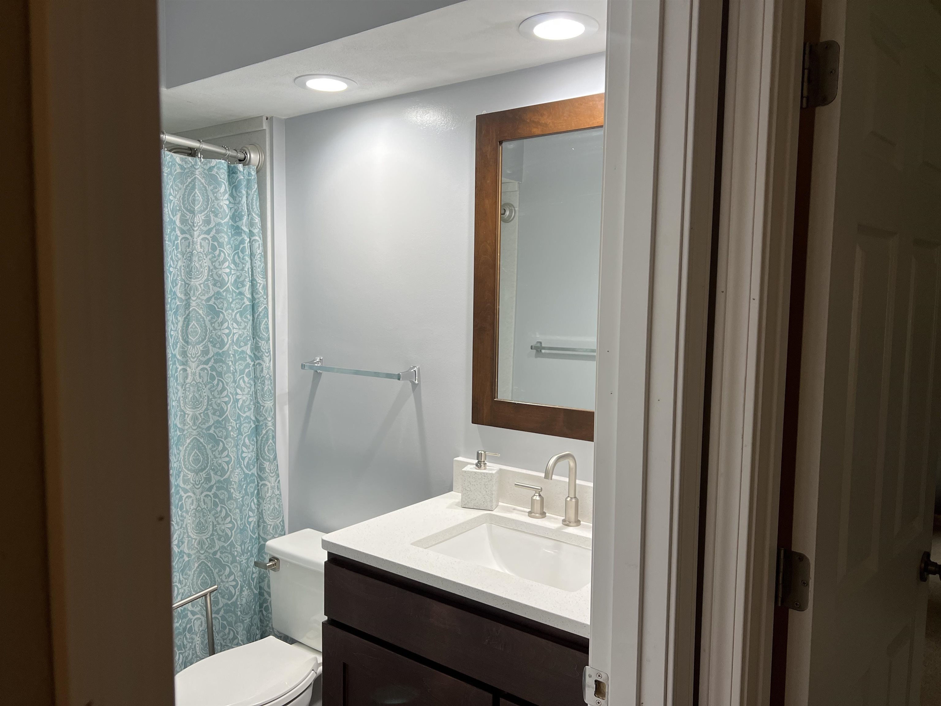 14 Spring Brook Road Rockford, IL 61114 - Photo 27 of 31 a bathroom with a sink a toilet a mirror and vanity