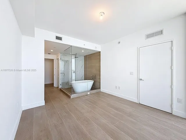 a spacious bathroom with a shower and a sink