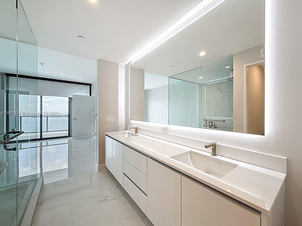 700 Northeast 24th Street, Unit 1402 Miami, FL 33137 - Photo 15 of 68 a bathroom with a sink and a mirror