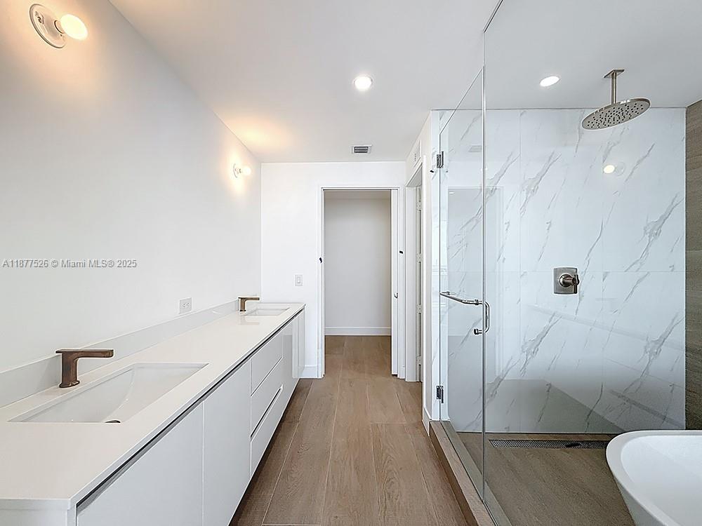 700 Northeast 24th Street, Unit 1402 Miami, FL 33137 - Photo 17 of 68 a bathroom with a double vanity sink toilet and shower