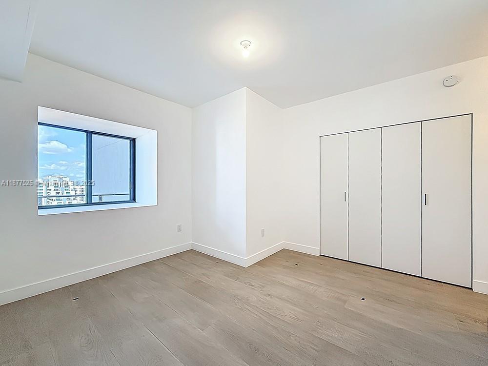 700 Northeast 24th Street, Unit 1402 Miami, FL 33137 - Photo 24 of 68 a view of an empty room with closet