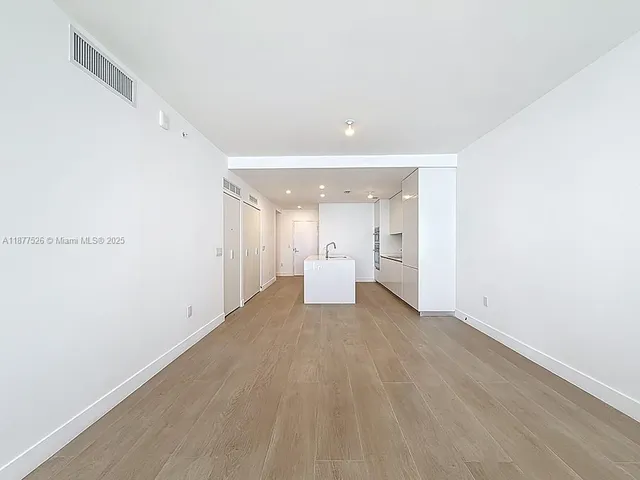 a kitchen with a sink and a refrigerator