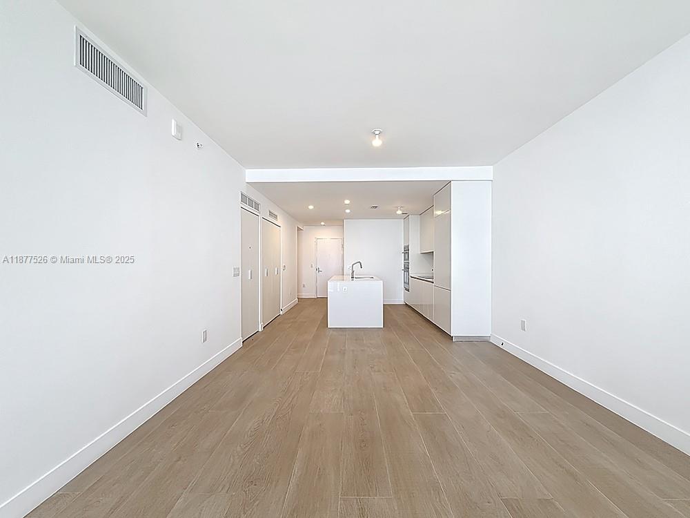 700 Northeast 24th Street, Unit 1402 Miami, FL 33137 - Photo 5 of 68 a view of a room with a refrigerator and window