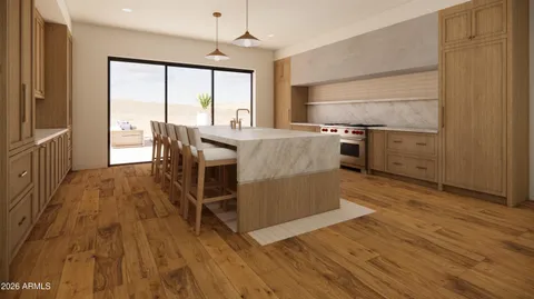 a kitchen with wooden floors and white walls