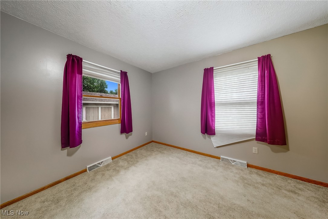 425 Overlook Drive Rittman, OH 44270 - Photo 13 of 44 Spare room with carpet and a textured ceiling