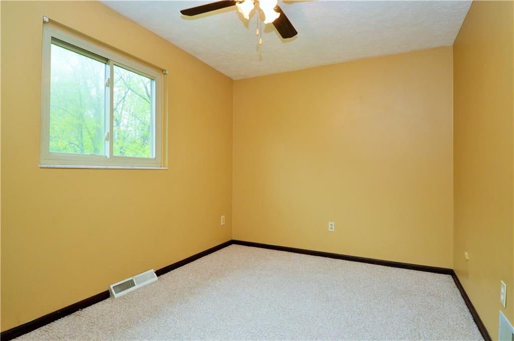 1023-1025 Moon Run Road McKees Rocks, PA 15136 - Photo 16 of 25 an empty room with a window and chandelier fan