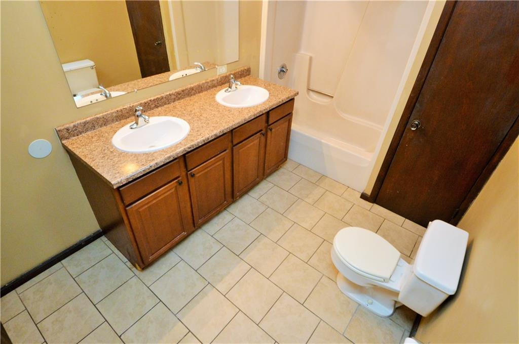 1023-1025 Moon Run Road McKees Rocks, PA 15136 - Photo 17 of 25 a bathroom with a sink a toilet and mirror