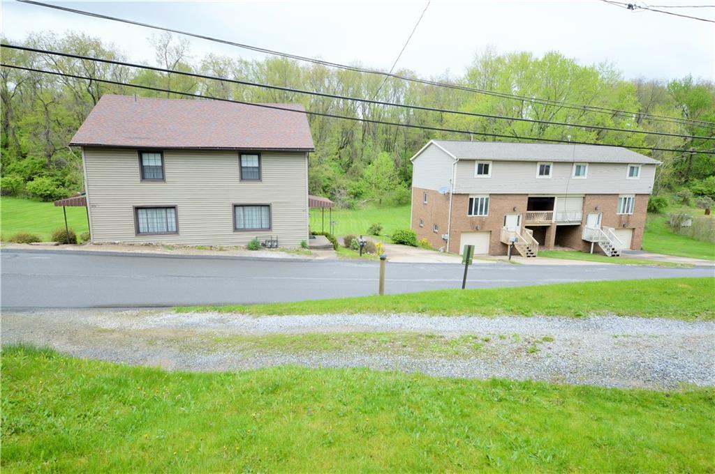 1023-1025 Moon Run Road McKees Rocks, PA 15136 - Photo 2 of 25 a front view of a house with garden