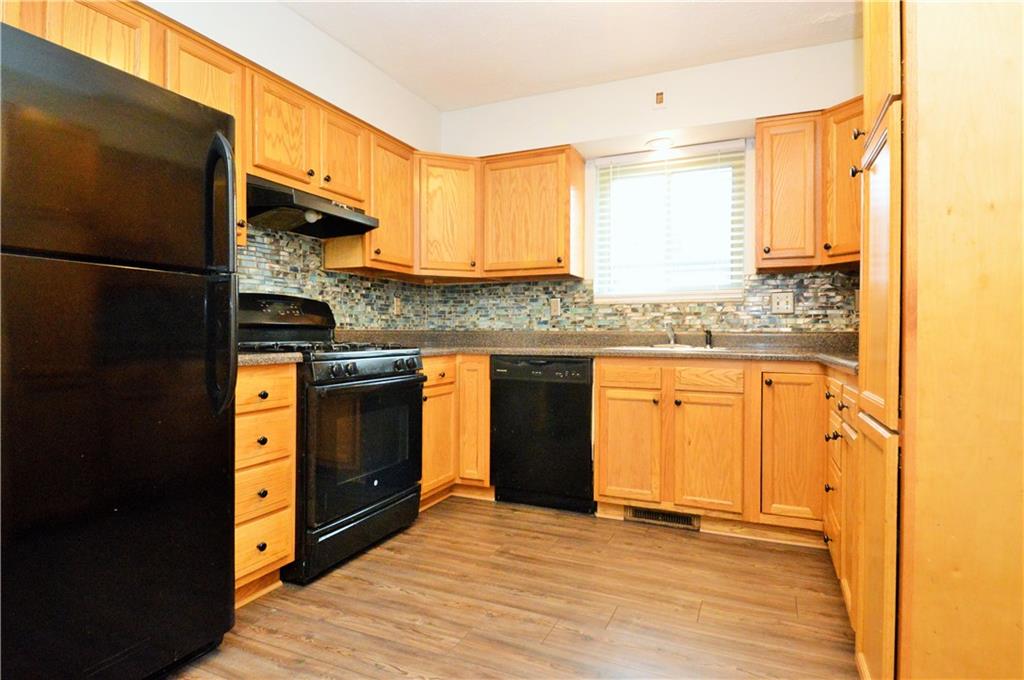 1023-1025 Moon Run Road McKees Rocks, PA 15136 - Photo 6 of 25 a kitchen with stainless steel appliances granite countertop a stove a sink and a refrigerator