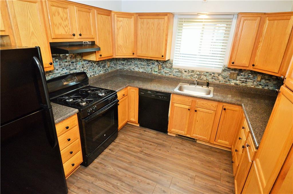 1023-1025 Moon Run Road McKees Rocks, PA 15136 - Photo 7 of 25 a kitchen with stainless steel appliances granite countertop a stove a sink and a microwave