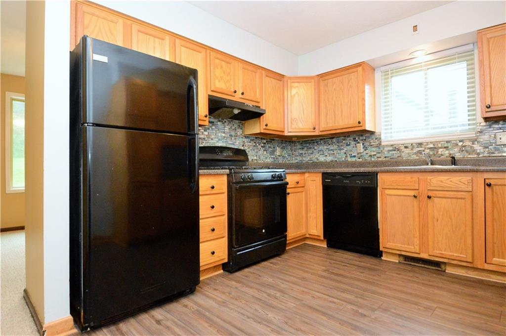 1023-1025 Moon Run Road McKees Rocks, PA 15136 - Photo 8 of 25 a kitchen with stainless steel appliances granite countertop a refrigerator a sink and a stove