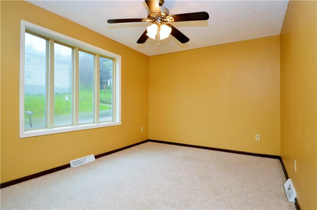 1023-1025 Moon Run Road McKees Rocks, PA 15136 - Photo 9 of 25 an empty room with a window and a ceiling fan