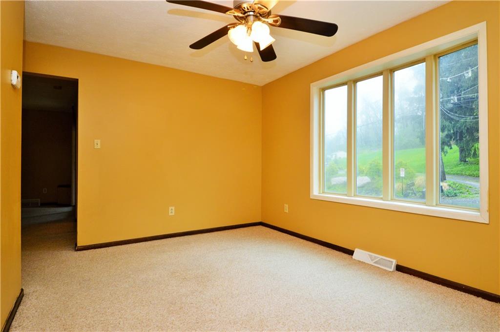 1023-1025 Moon Run Road McKees Rocks, PA 15136 - Photo 10 of 25 a view of an empty room with chandelier fan and a large window