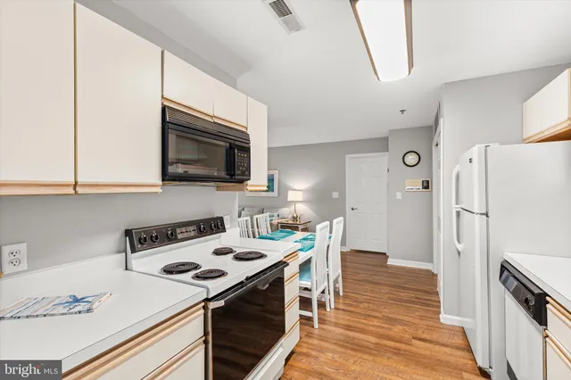 a kitchen with a stove a sink and a refrigerator