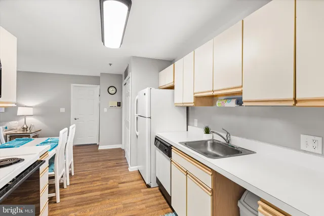 a kitchen with a sink a stove and cabinets