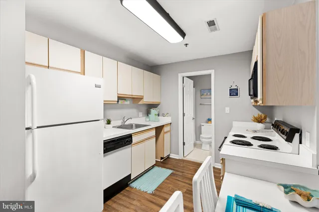 a kitchen with a white cabinets and white appliances