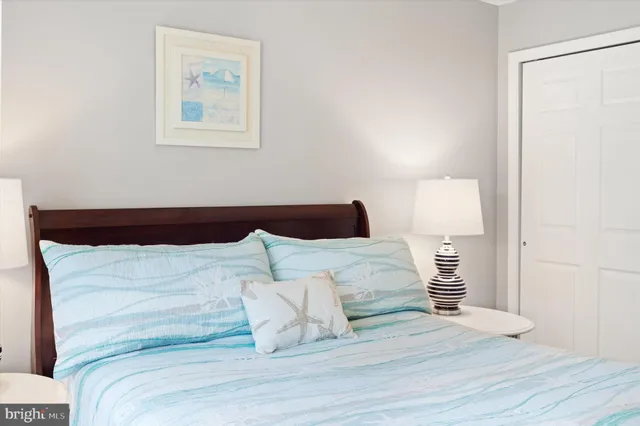 a bedroom with a bed and a night stand