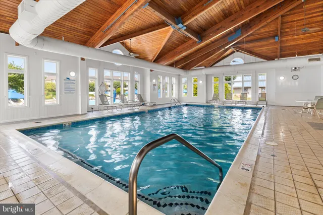 a bathroom with a tub a sink and a large window